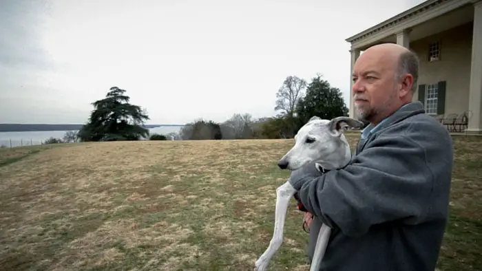 Mark Sutherland holds Abby the whippet outside Mount Vernon on their heartfelt journey