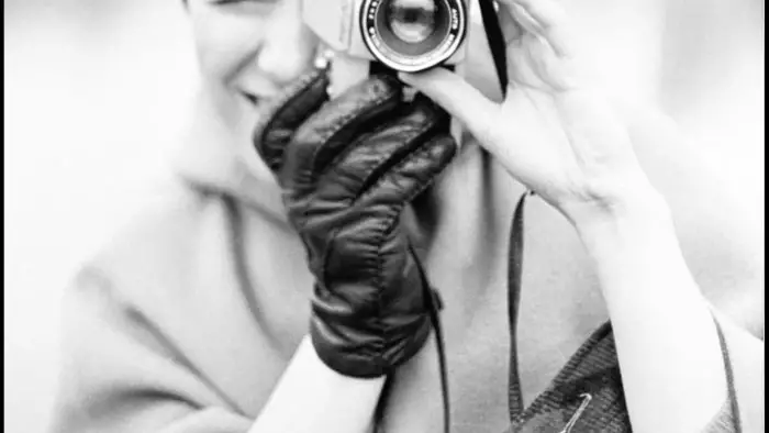 Sheila Turner Seed holding a camera in an archival black-and-white portrait from the late 1960s.