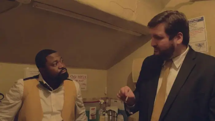 Two theater employees talk in a back room in Movie Theater Massacre