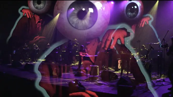 Concert stage with eerie eyeball animation overlay from The Dark Fantastic