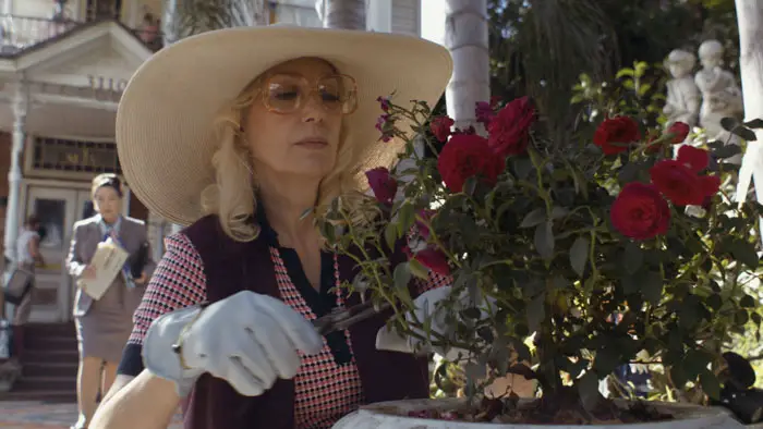 Susan Priver as Dorothea Puente trimming roses in Dorothea