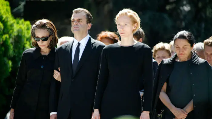 Scene from I Am Love featuring Tilda Swinton and other characters at a funeral.