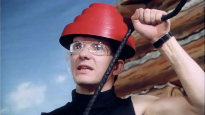 Devo band members performing in their red energy dome hats.