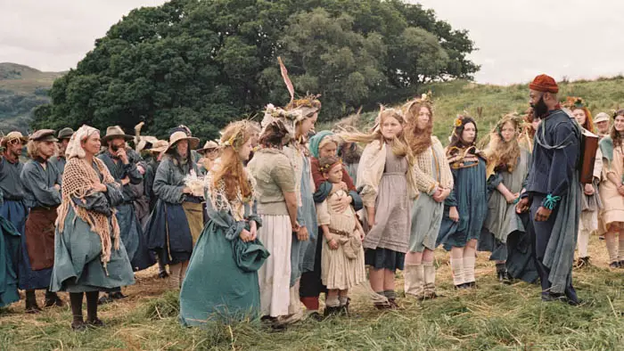 Villagers gather in the fields during a harvest ritual in Harvest (2024).