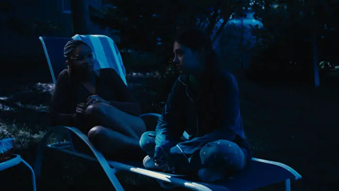 Raquel Sciacca and Didrianna Foreman share a quiet nighttime conversation in How I Spent My Summer Vacation. 