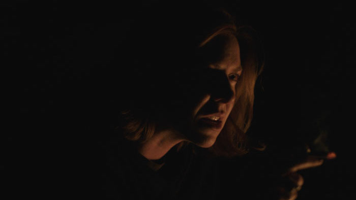 Renee Gagner as Parker in a dimly lit scene from I’ve Seen All I Need to See