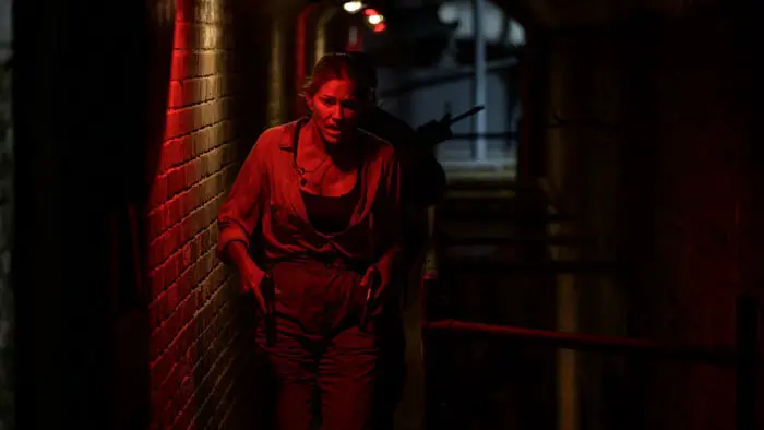 A woman in a red-lit corridor in Primitive War
