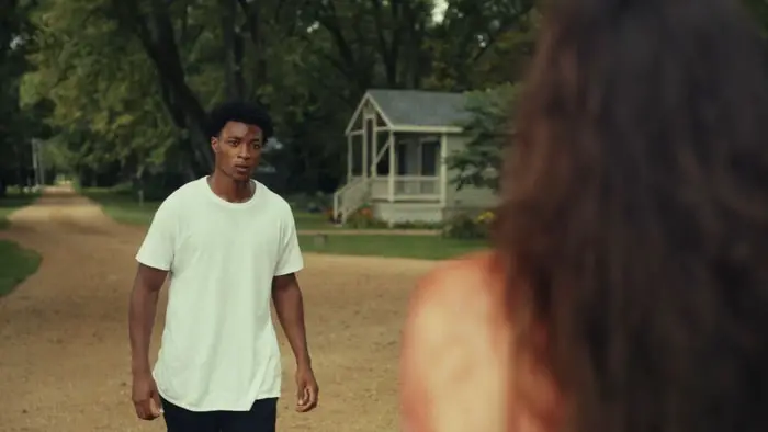 Malachi approaches a mysterious, bloodied woman standing in the street.