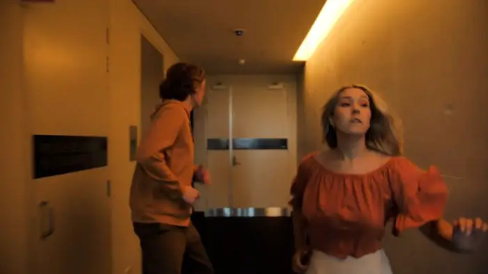 Sonny and Angelica running through a hallway in The Wing Girl 