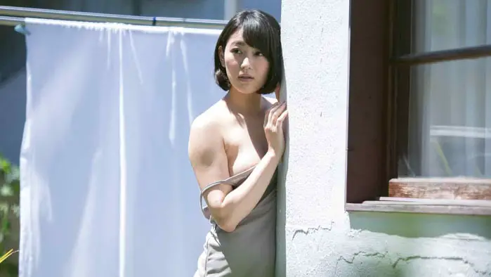 Woman standing outside in a scene from Aroused by Gymnopedies