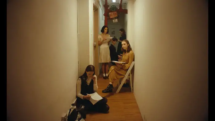 Actresses wait in a cramped hallway before auditions in Crying on Command