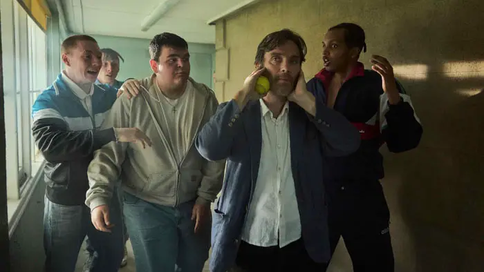 Cillian Murphy as Steve walking down a school hallway surrounded by troubled students