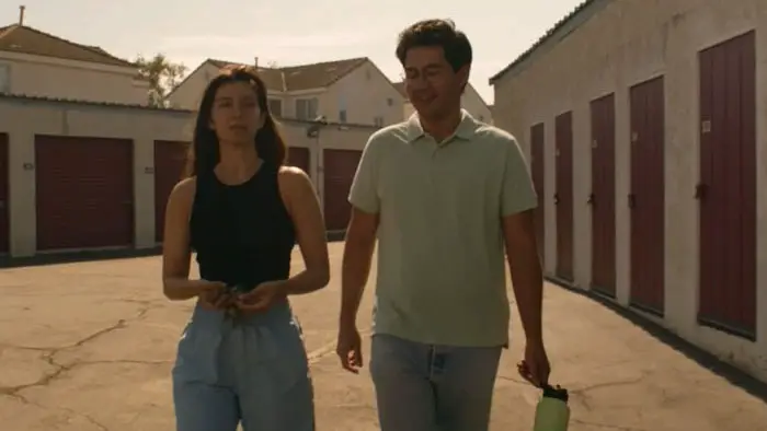 Margo and Jerry walking together outside a row of storage units in the short film Storage.