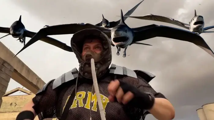 A man in tactical gear runs as flying mutant sharks with wings attack from above in Narco Sharks (Narco Shark 2).