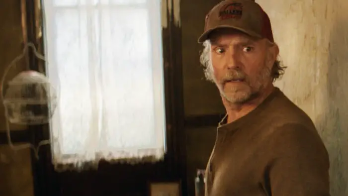 John Pyper-Ferguson as Jim Murdoch looking over his shoulder inside the lighthouse