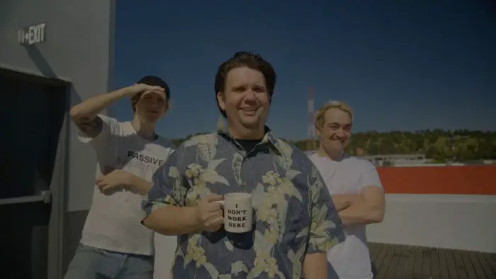 Cast members standing on a rooftop with a blue sky background from Ramzi Abed’s First Person Savior