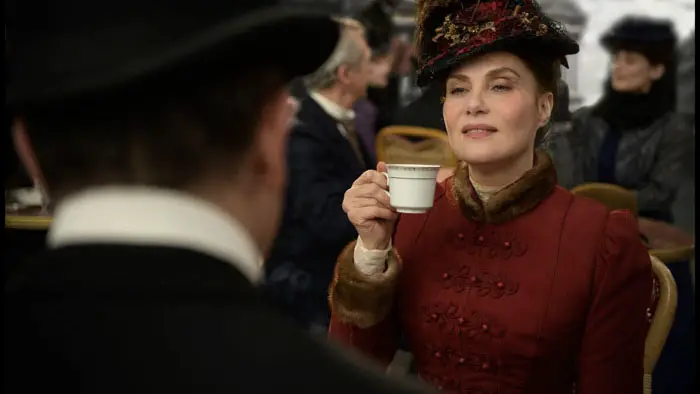 Emmanuelle Seigner holding a teacup during a café scene in An Officer and a Spy
