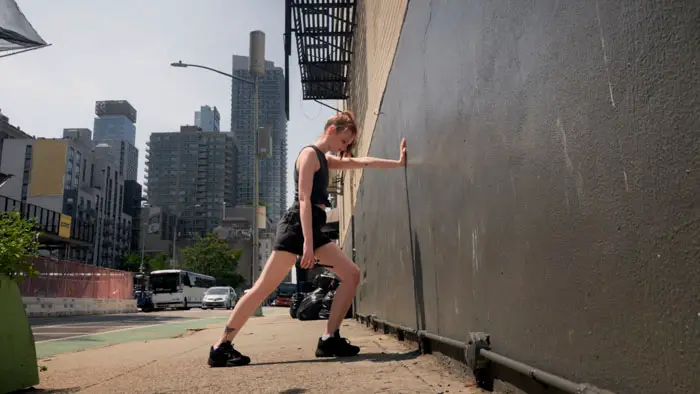 Claudia Thiedmann as Karla stretches against a wall in New York City in Bread and Butter. 