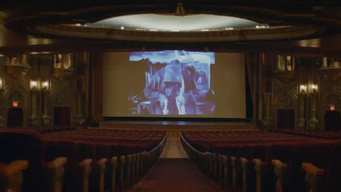 Movie still from Capio showing a projection in an ornate theater