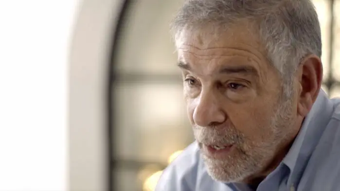 A close-up of a man speaking during an interview in the documentary For the Living.