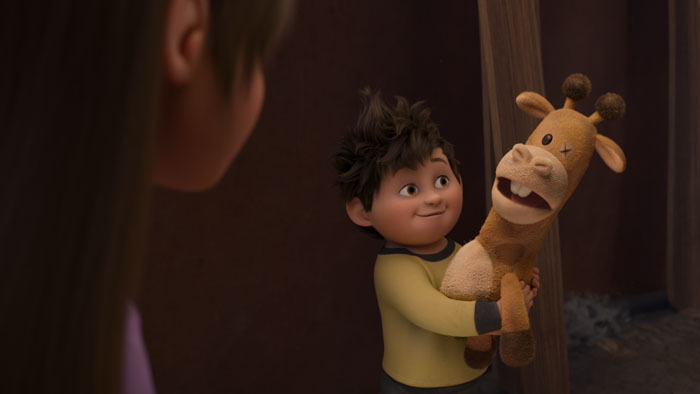 Stevie’s little brother Elliot excitedly holds up Baloney Tony the stuffed giraffe in a scene from In Your Dreams.