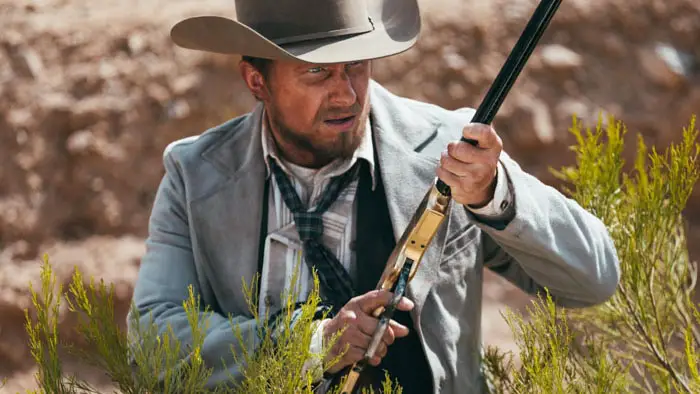 Dermot Mulroney aims a rifle in the western film Long Shadows