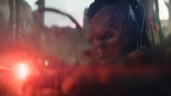 The Predator Dek aims his weapon in a jungle battle on the planet Genna.