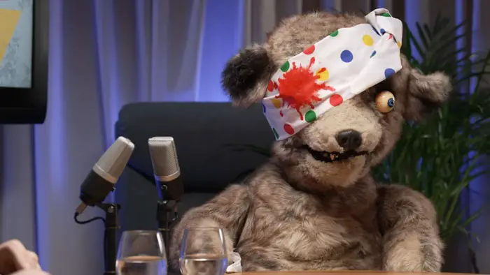 Pads, the Spitting Image bear, dressed in a parody of Pudsey Bear with a spotted eye bandage.