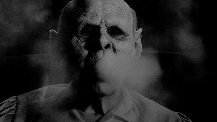 A demonic, wrinkled figure exhales smoke in the psychological thriller Starmaker.