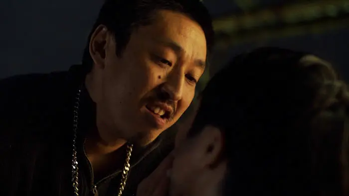 A Yakuza member confronts his victim in a tense scene from Hiroshi Shôji’s Tatsumi 