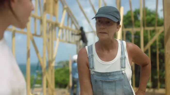 Suzanne Kovi working on a house frame in the Bahamas in a scene from There’s Something I Have to Tell You 