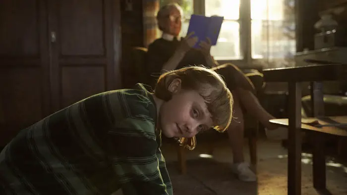 Glenn Close and Emily Matthews share a quiet moment inside a rustic island cottage in The Summer Book (2025).