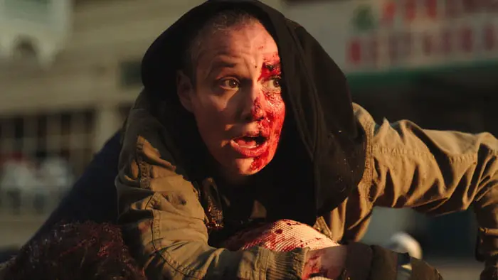 Bloodied survivor scrambling to safety during the outbreak in Wormtown (2025).