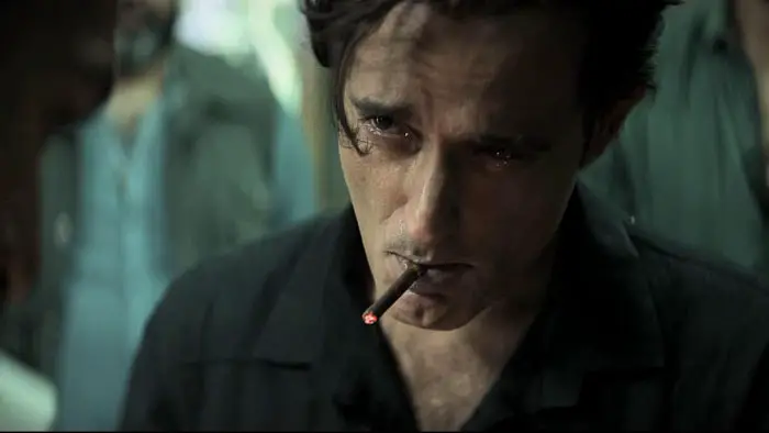 Close-up of Rehman Dakait with a cigarette in a tense, moody scene from Dhurandhar (2025).