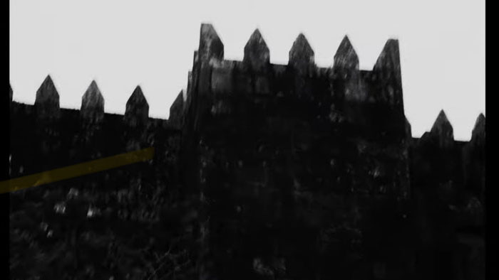 Black-and-white silhouette of a jagged fortress wall with pointed spikes along the top. 