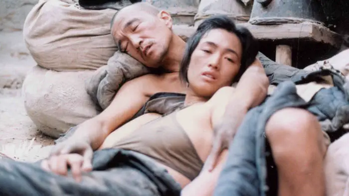 Ju Dou (Gong Li) and Tianqing (Li Baotian) in an intimate moment inside the rural dye mill in Ju Dou (1990)