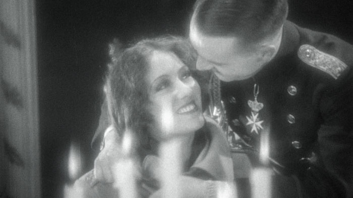 Patricia Kelly (Gloria Swanson) smiles up at Prince “Wild” Wolfran (Walter Byron) in a romantic palace moment from Queen Kelly.