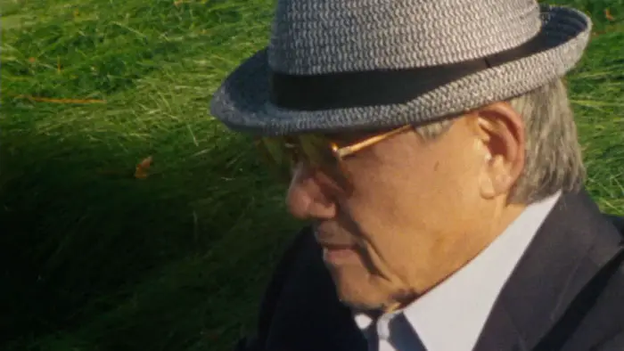 Jim Lau as Xinhao resting in a field of grass in After That (2026)