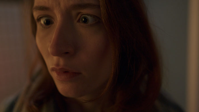 Crystal Loverro as Maria reacting in fear after an alien crash in Blindsided (2025)