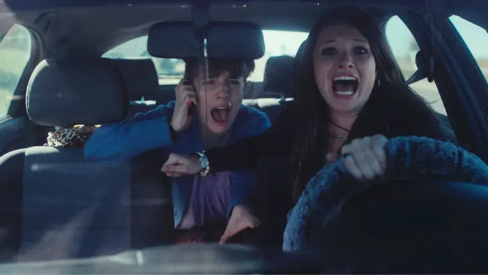 Autumn Best and Zoe Colletti shout inside a moving car in BRB (2026)