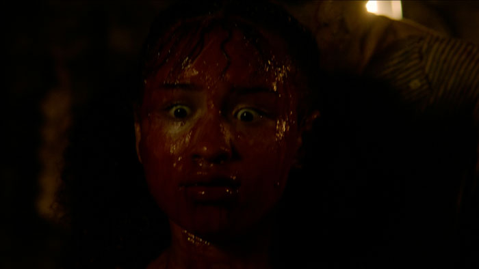 Lilith Mesidor in Dead Bloom (2026) covered in blood during transformation scene