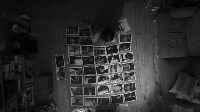 Overhead shot of photographs spread across the floor in Dump of Untitled Pieces (2026) 