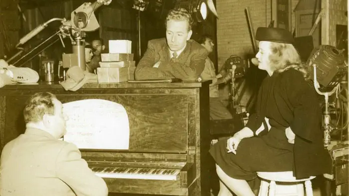 Erich Wolfgang Korngold at the piano during a rehearsal of Deception with actors Paul Henreid and Bette Davis