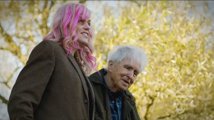 Magda (Melissa De Mol) and Guy (Alan Breck) walking together outdoors in Gone to Ground (2026)
