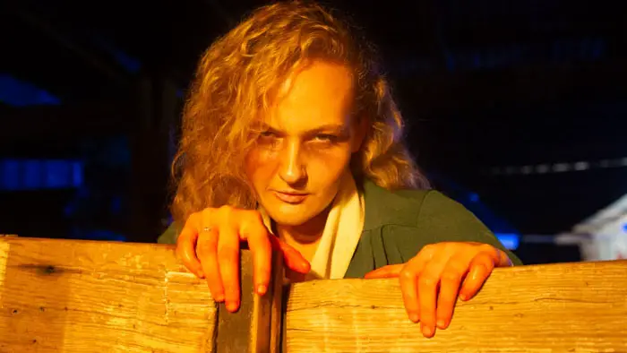 Lisa Butala as the ghostly woman in green in Sundown (2026)