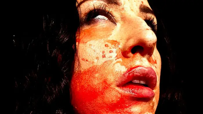Close-up of a blood-covered victim in The Treatment and the Cure (2026)