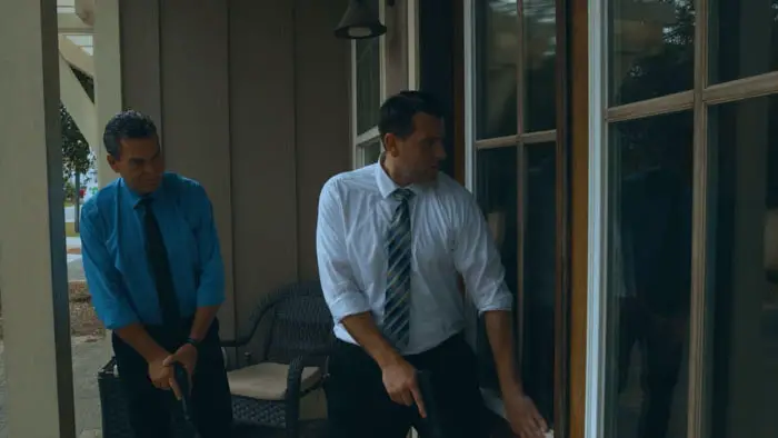 Stewart and Jeremy, played by Vinny Giovanniello and Edward W. Johnson, prepare to enter a building in Contention.