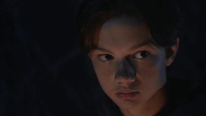 A teenage boy looks nervously into the darkness in Goblin II.