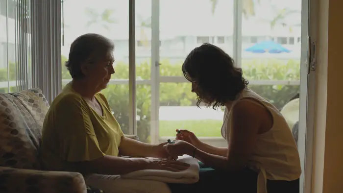 A daughter gives a manicure to her mother in a quiet moment in How to Clean a House in Ten Easy Steps (2026)