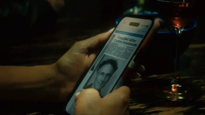 A woman covered in blood speaks on a phone in a dark scene from Night of 5